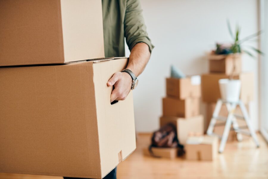 Close Up,of,a,man,with,carton,boxes,moving,into,new